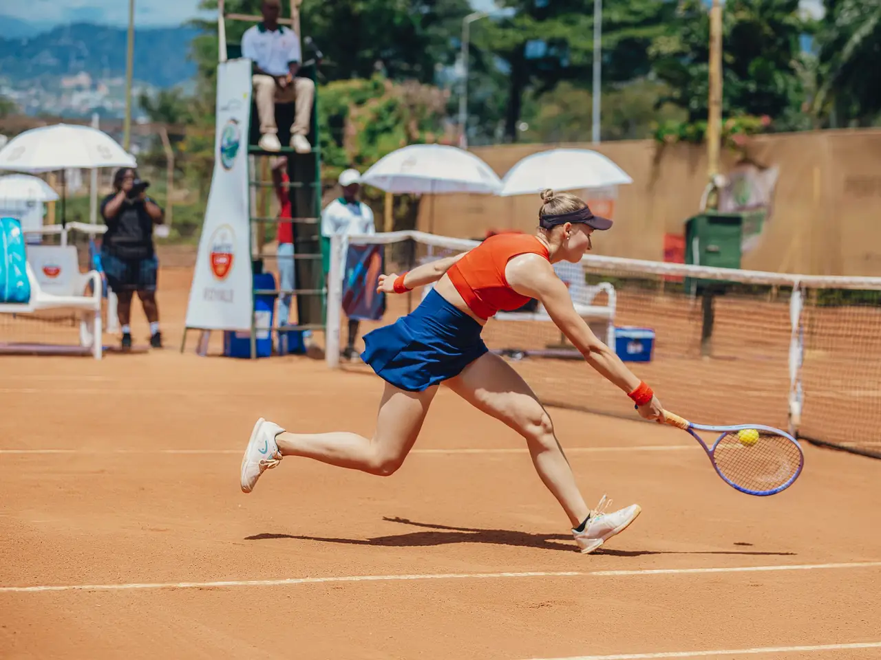 Tennis player serving on a clay court