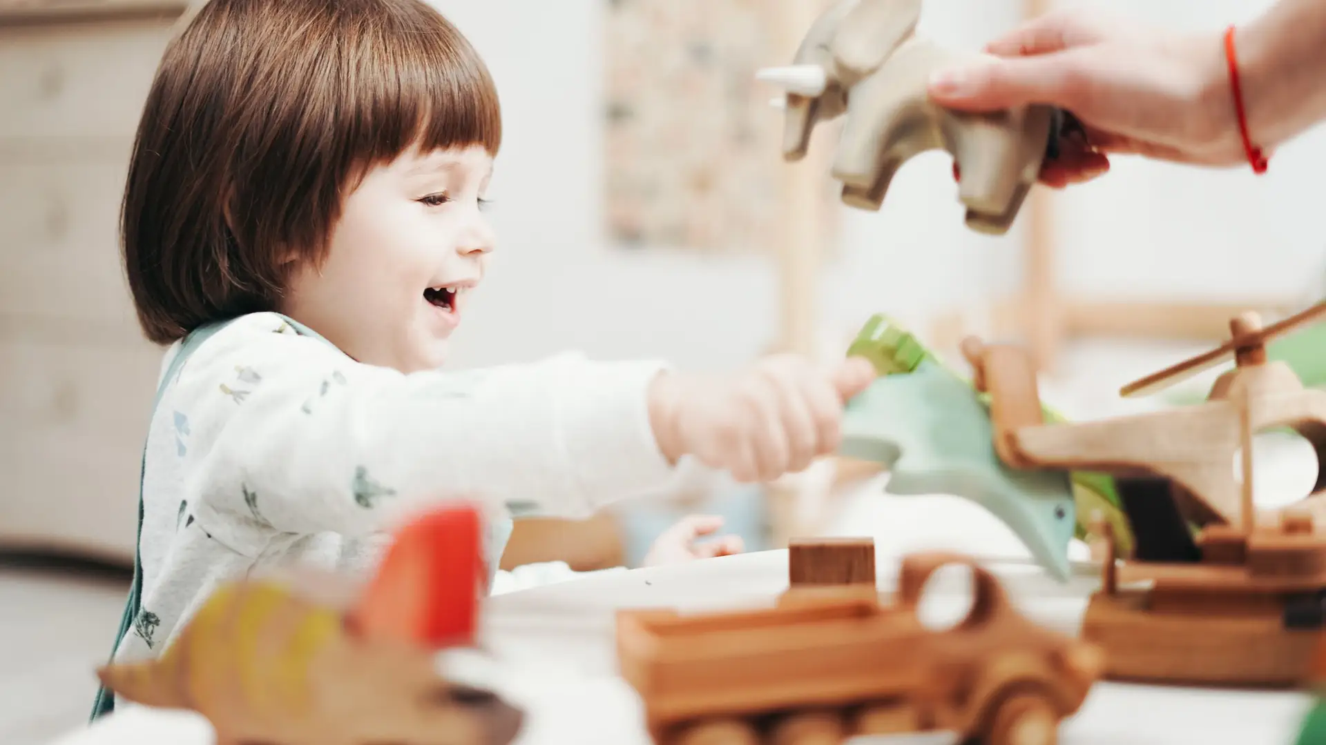 Child playing with wooden toys on a bright playroom floor