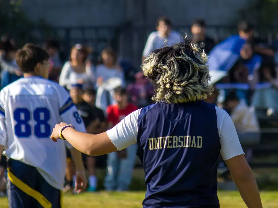 University students playing flag football on campus