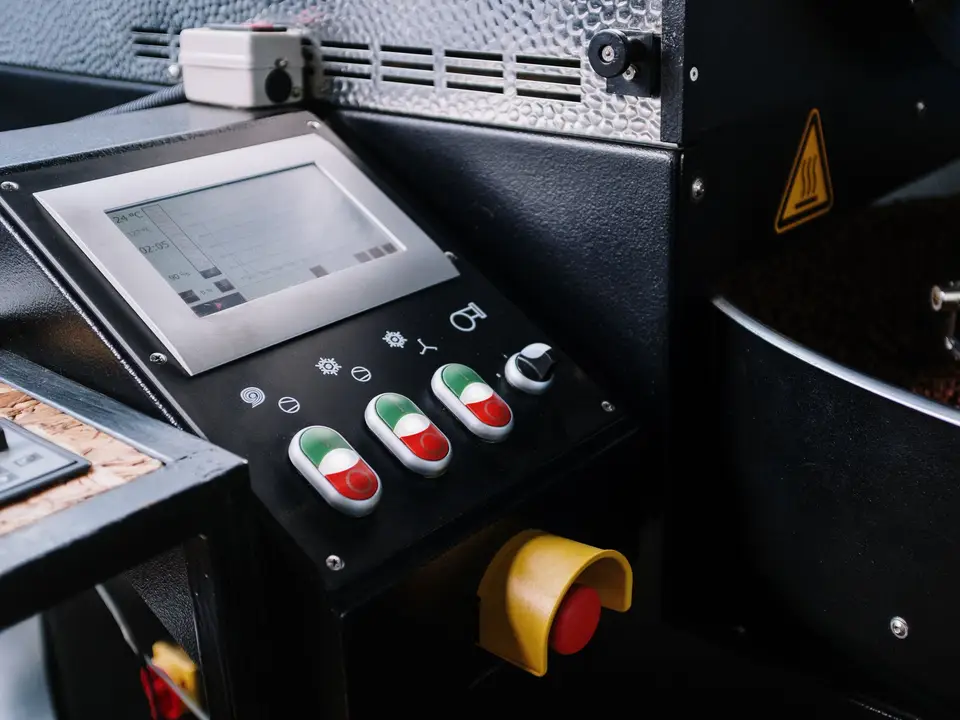 Roaster control panel with buttons and coffee beans