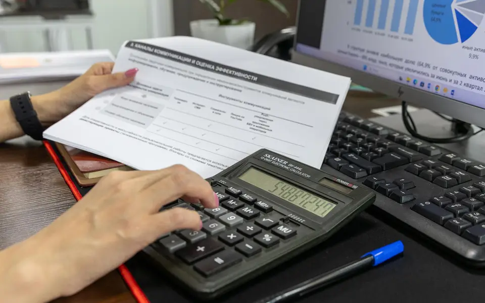 Printed financial statement on a desk beside seashells