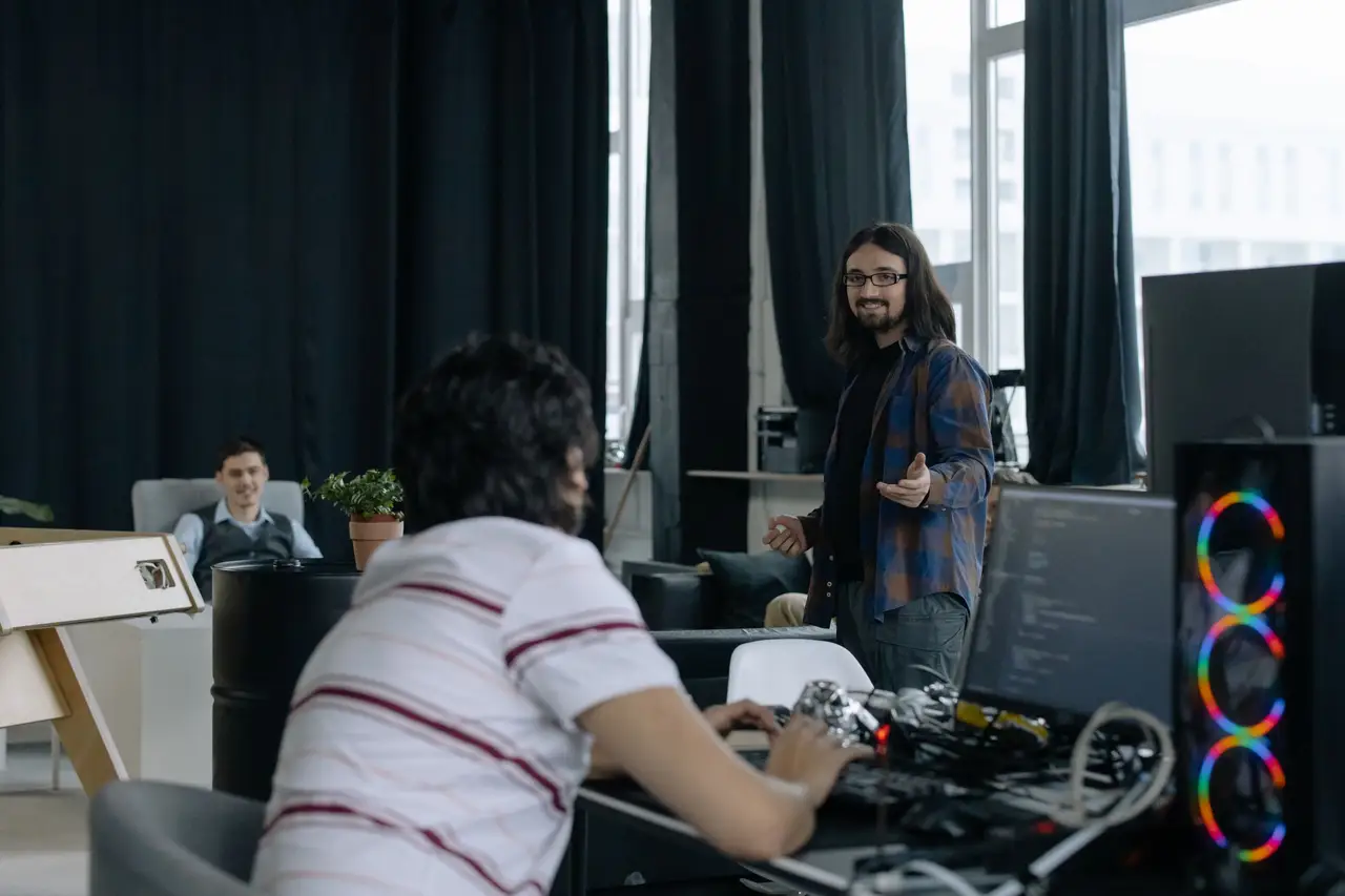 Studio team sketching business ideas on glass walls in a loft office