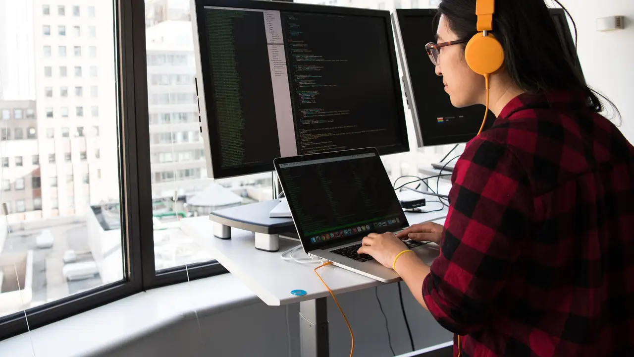 Designer refining a website layout on a monitor