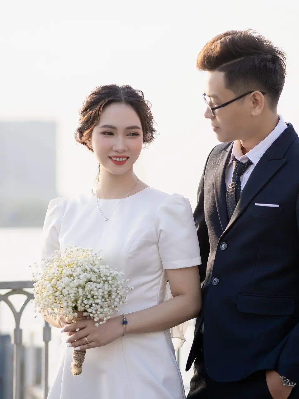 Couple on a bridge with a bouquet
